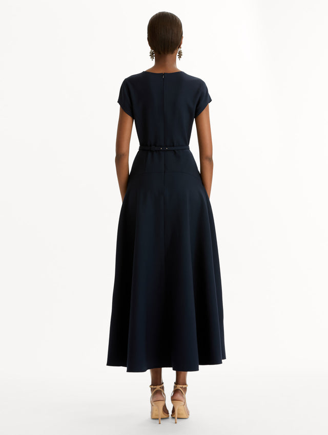 Navy Floral Belt Short Sleeve Dress with short sleeves and a belted waist featuring a white floral accent. Back View.