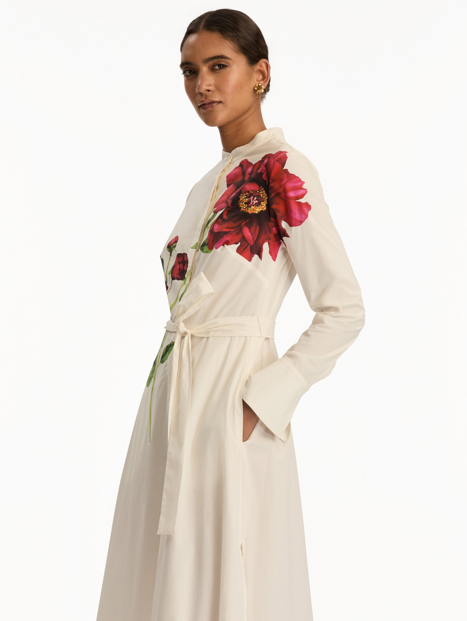 White long sleeve dress with printed pink peonies on bodice and self-tie closure along the waist. Zoom View.