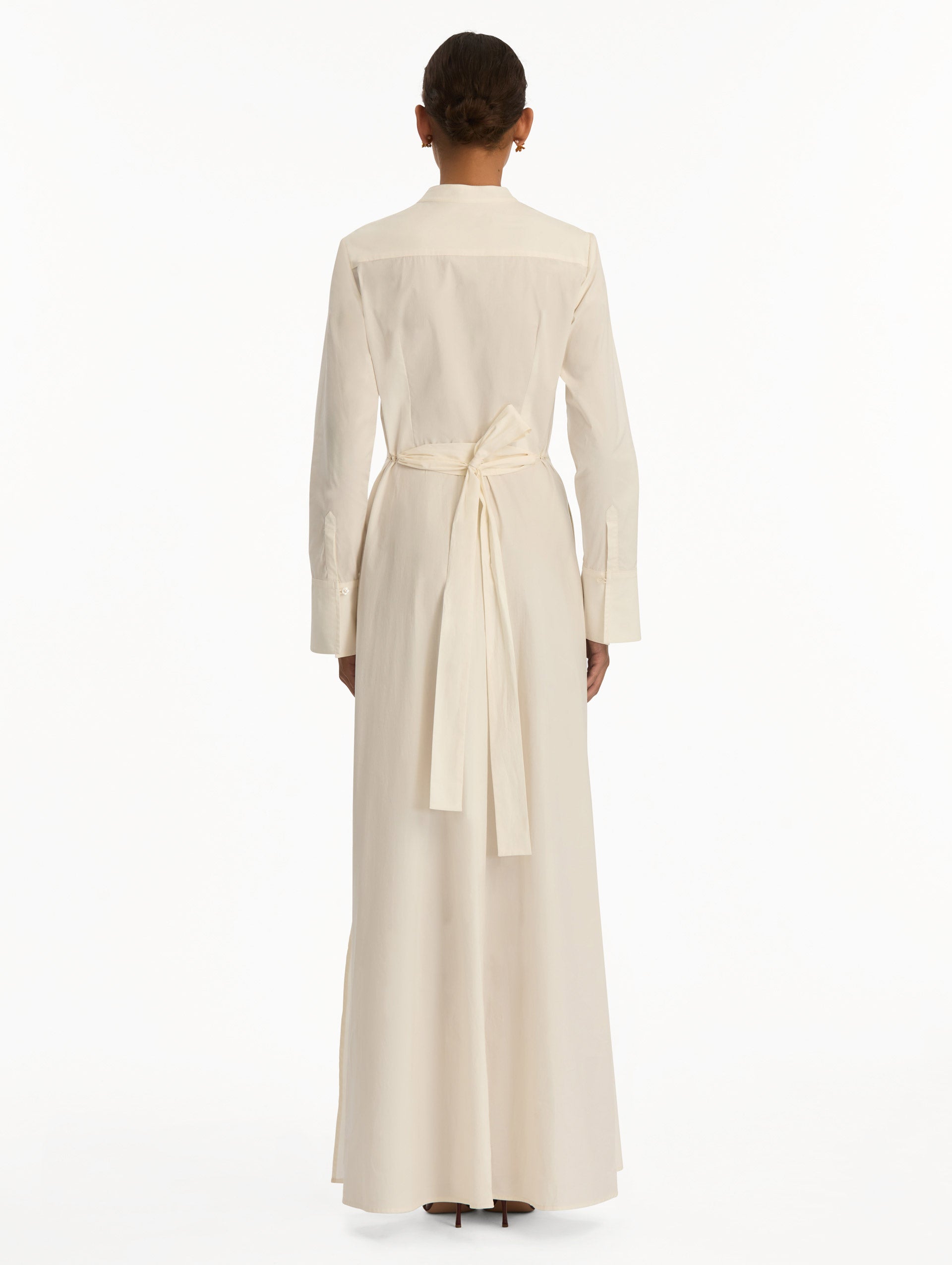 White long sleeve dress with printed pink peonies on bodice and self-tie closure along the waist. Back View.