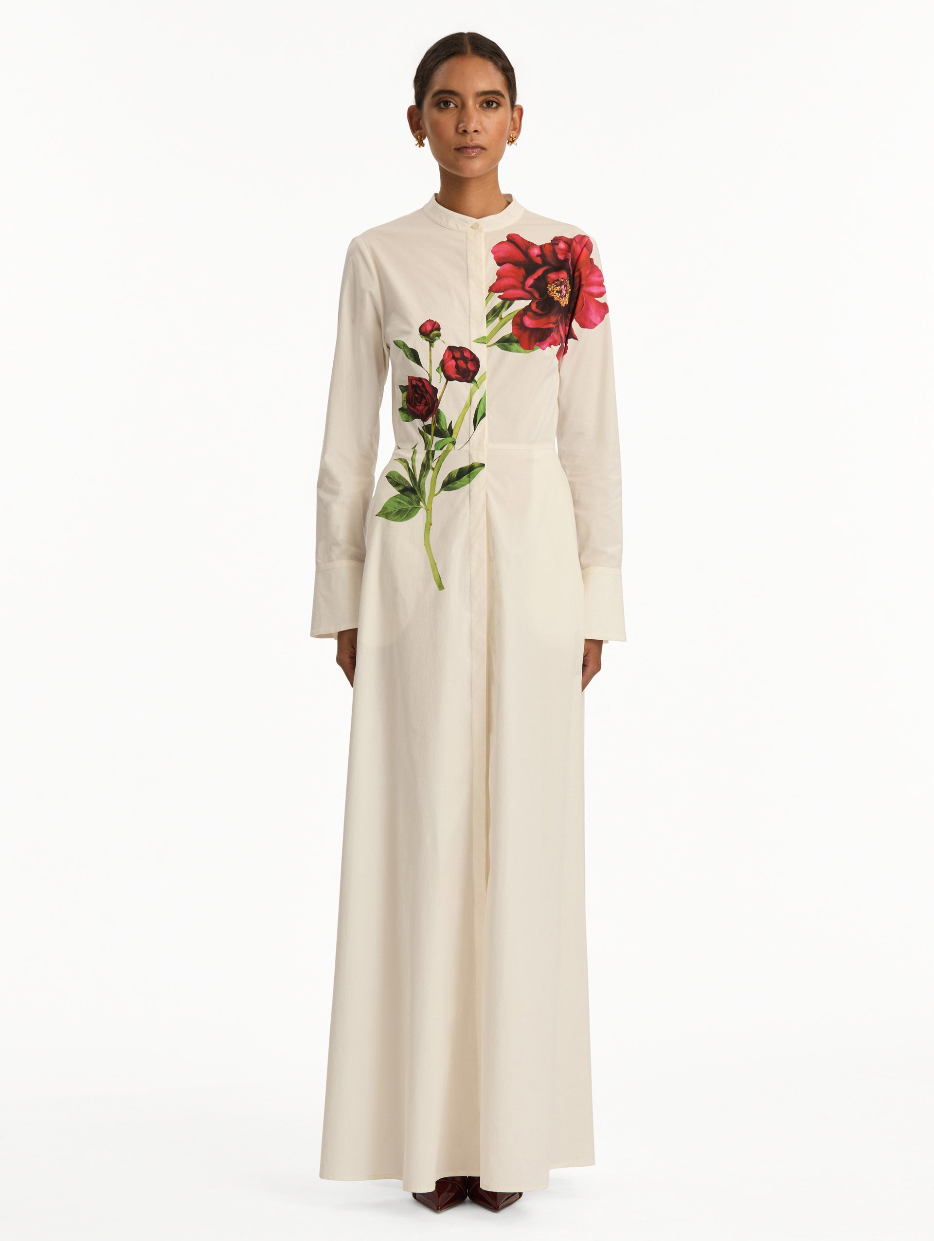 White long sleeve dress with printed pink peonies on bodice and self-tie closure along the waist. Front View.