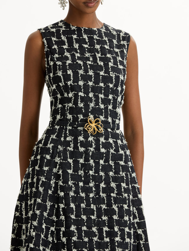 Black and Ivory Woven Denim Jacquard Midi Dress featuring a pleated skirt and belted waist with gold flower detail. Zoom View.