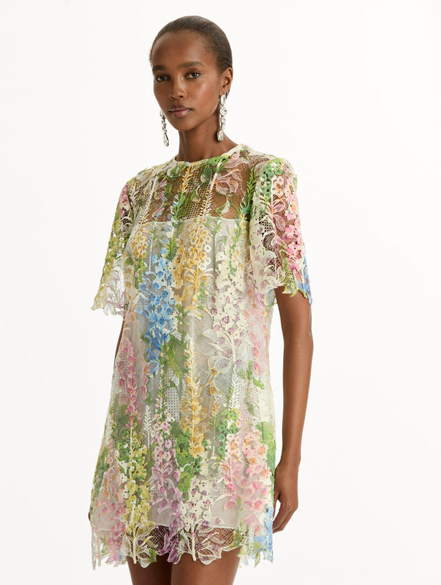 White and floral Foxglove Guipure Shift Dress with multi color sheer floral overlay and a white lining underneath. Zoom View.