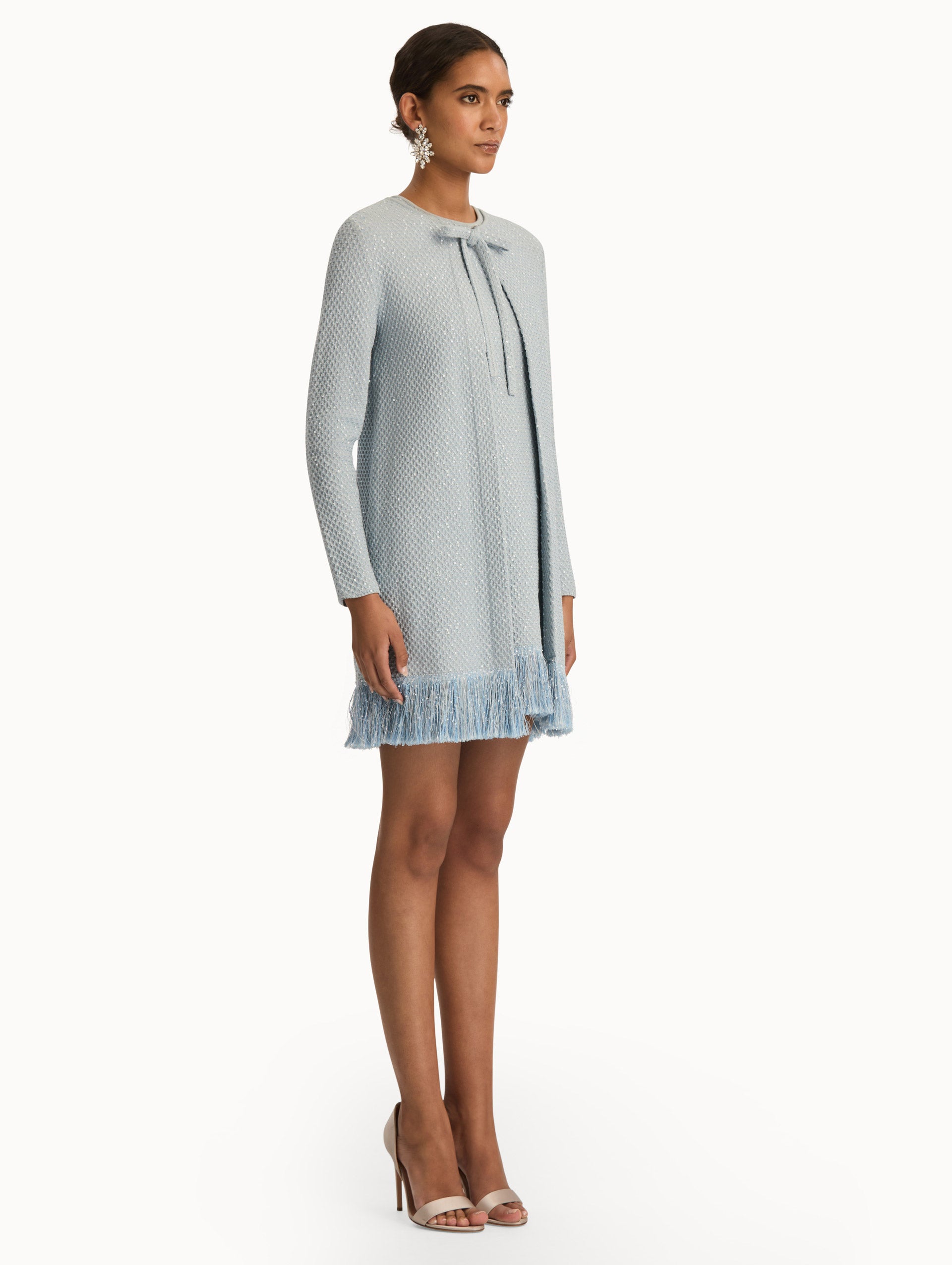 Blue quartz sequin tweed jacket with fringe trim. Side view.