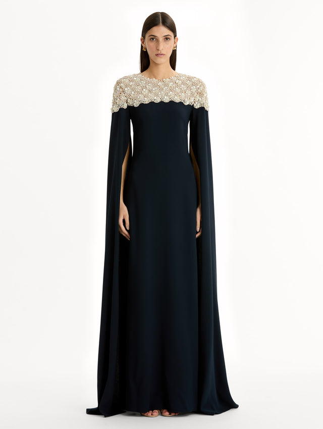 Navy Mother of Pearl Embroidered Caftan with ivory embroidered neckline and floor-length draped silhouette. Front View.