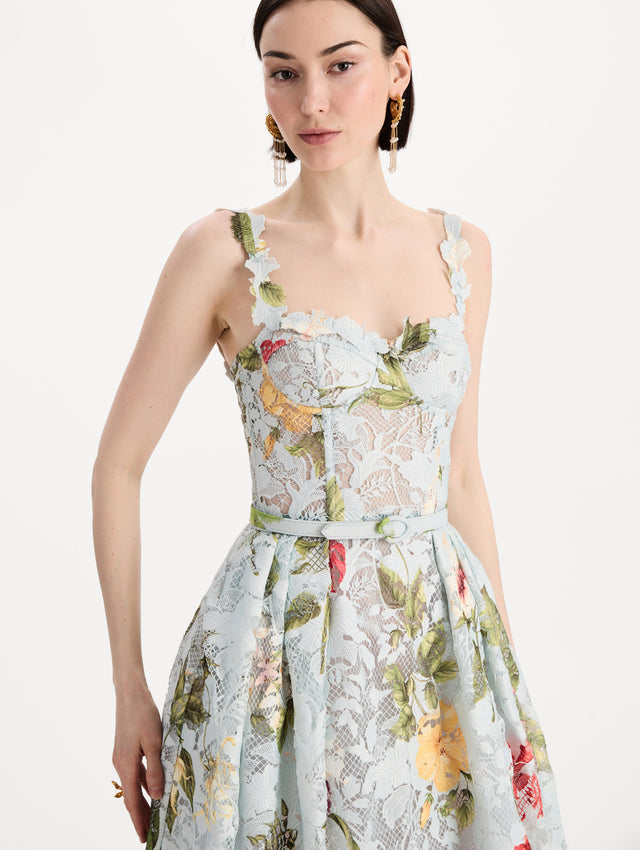 The model is wearing the Dominican Mixed-Floral Guipure Cocktail Dress in Saltwater Blue. Featuring floral detailing on straps, sweetheart neckline, structured bodice, and full skirt. Detail View.