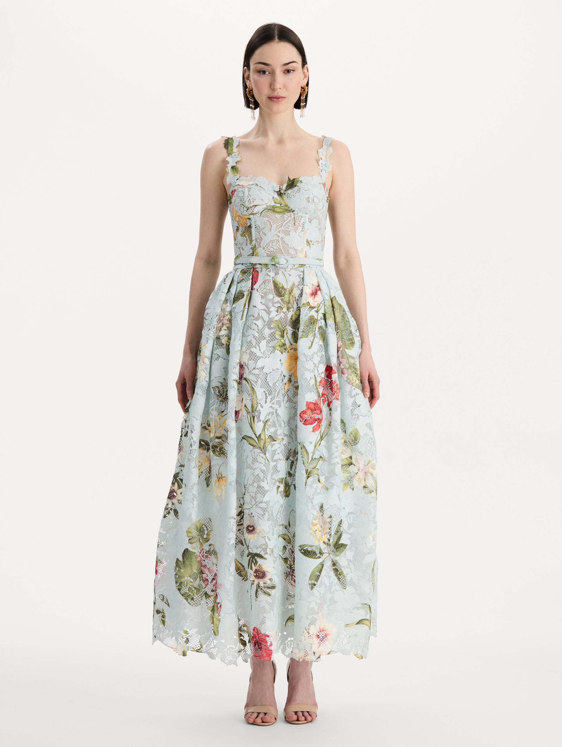 The model is wearing the Dominican Mixed-Floral Guipure Cocktail Dress in Saltwater Blue. Featuring floral detailing on straps, sweetheart neckline, structured bodice, and full skirt. Front View.