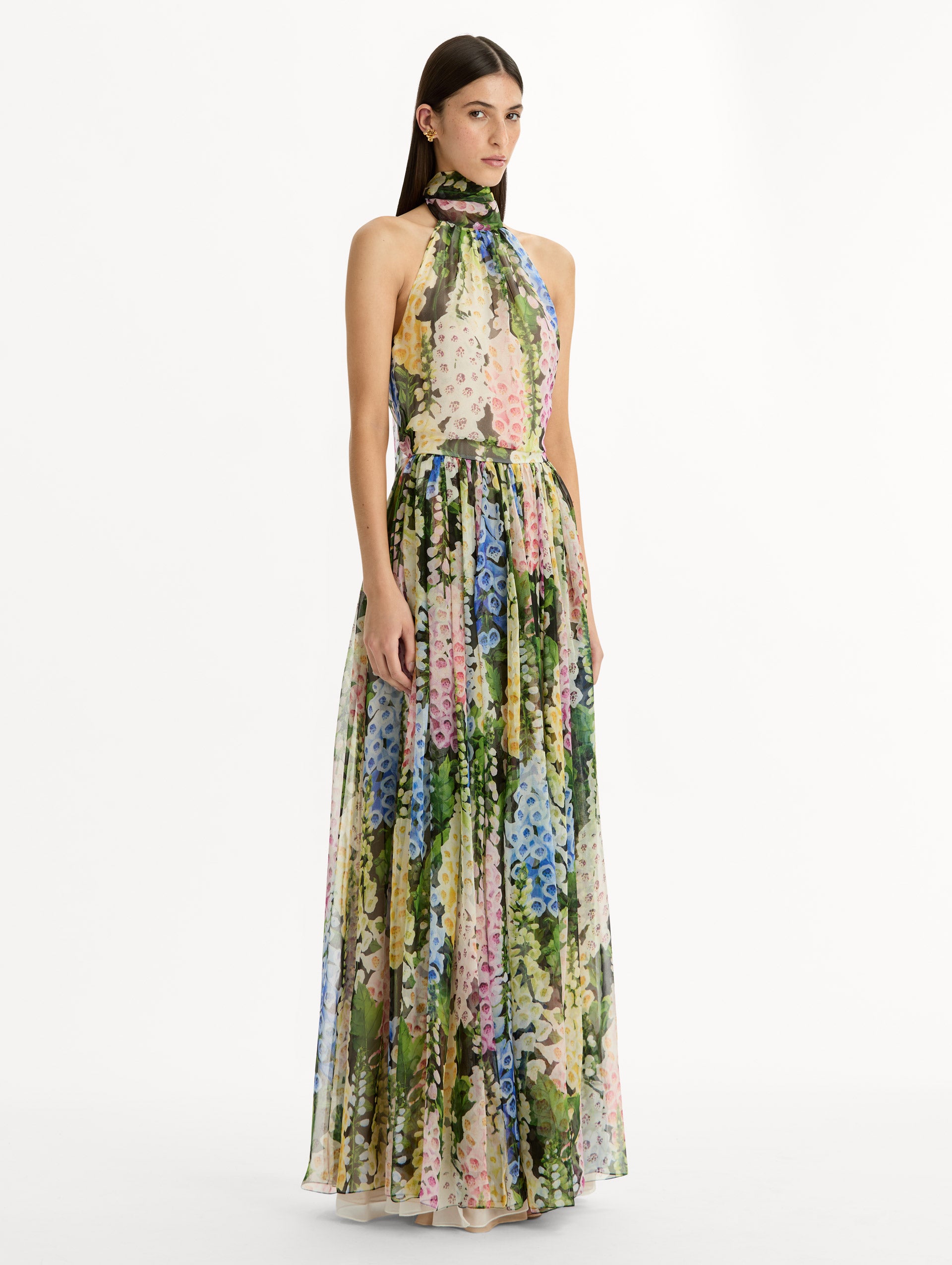 Floral Foxglove Chiffon Dress with high halter neck and pleated flowing chiffon skirt sinched at the waist. Side View.