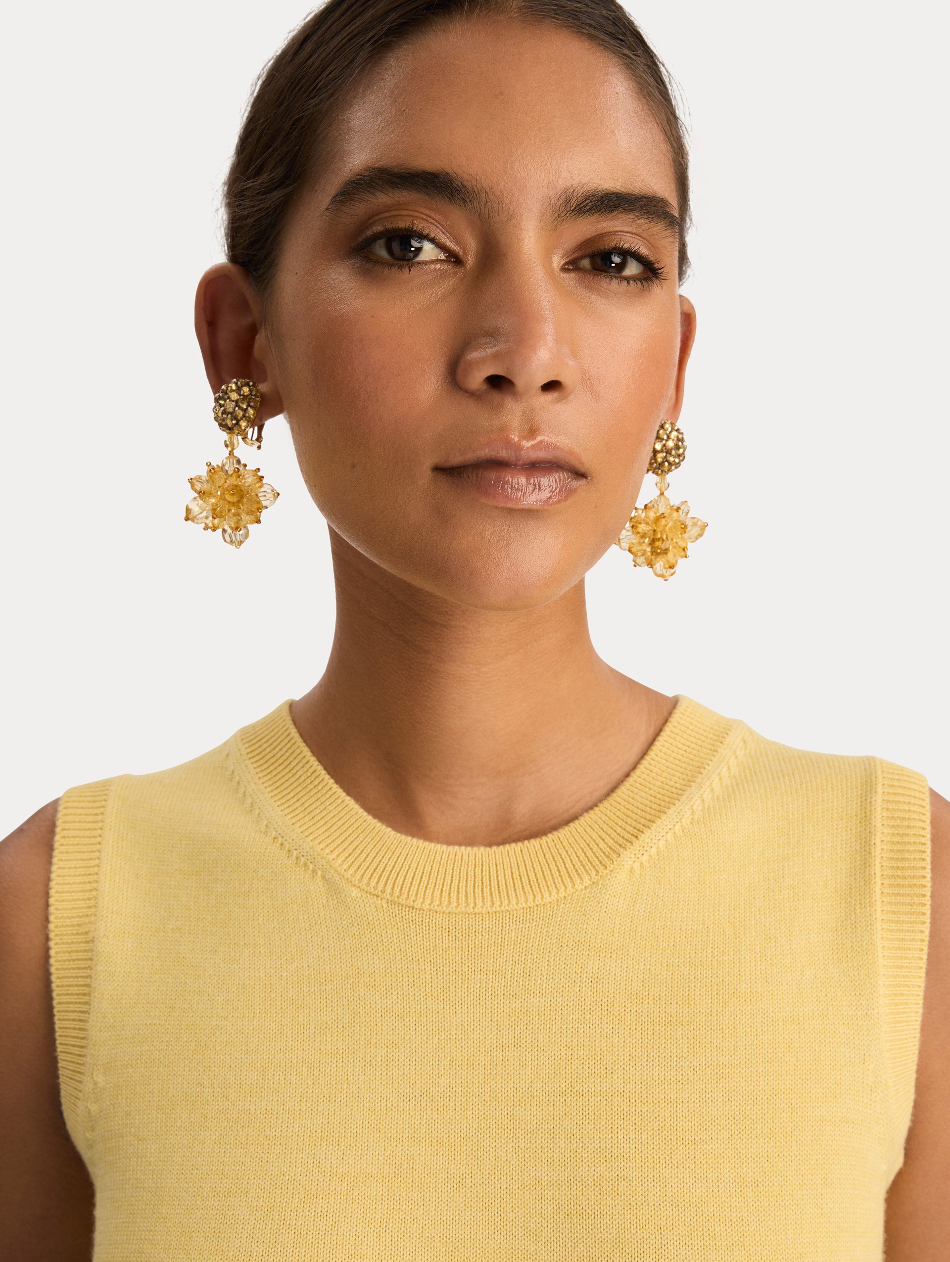 Yellow Beaded Pompom Clip-On Earrings featuring clustered beaded studs with yellow crystal petals forming a flower. Front View.