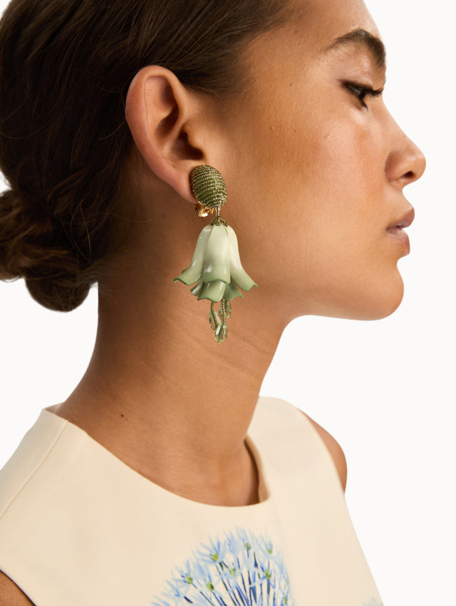 Green Impatiens Clip-On Earrings with petal-like forms suspended from a textured beaded stud, finished with dangling crystal teardrops. Side View.