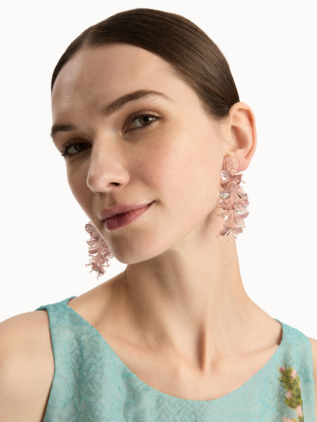 Pink Sequin Tassel Clip-On Earrings featuring layered translucent petals cascading from a round woven stud. Front View.