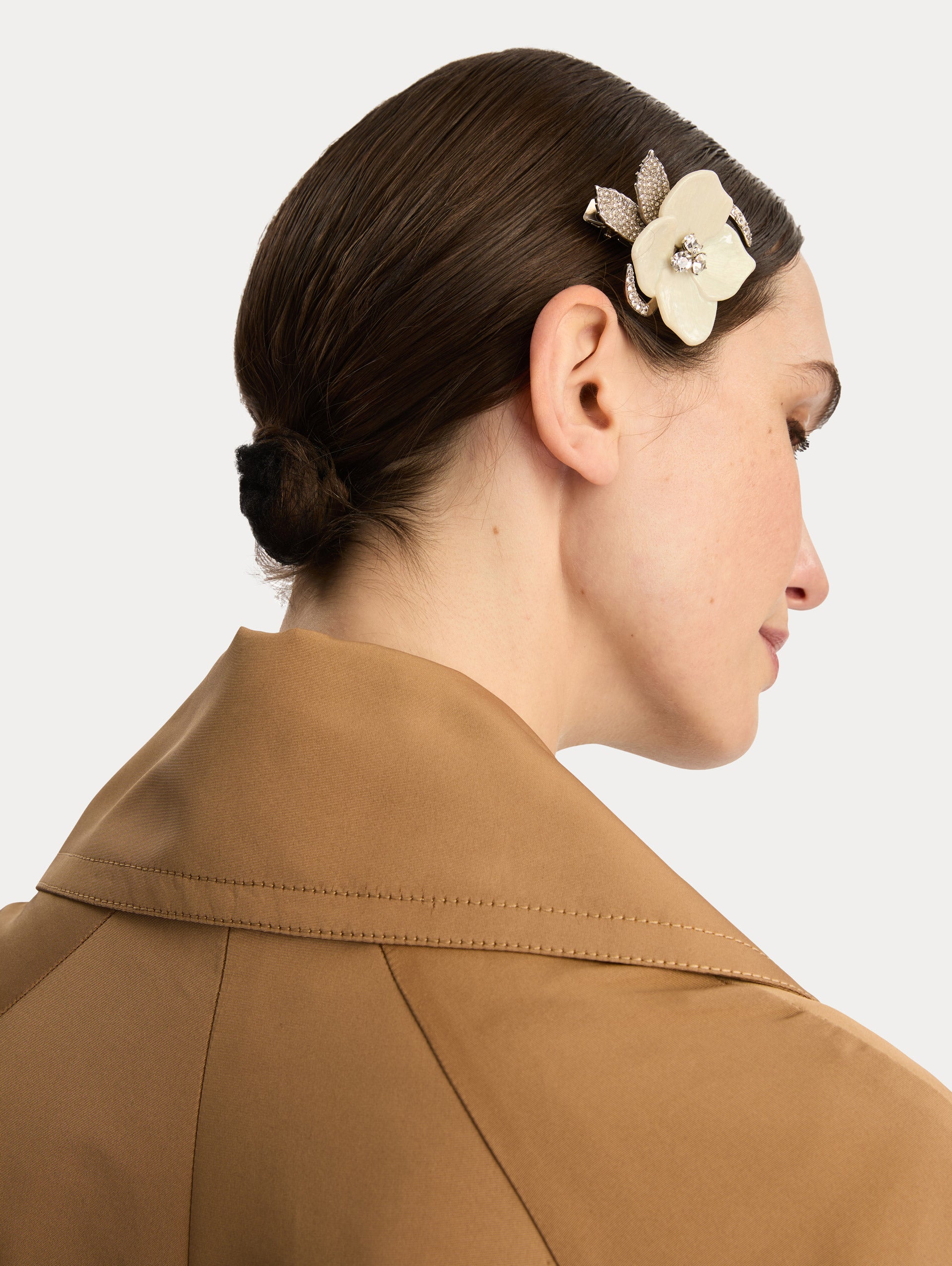 Silver and white Pearl Blossom Hair Clip featuring enamel petals with crystal accents and pavé-detailed silver leaves. Side View.