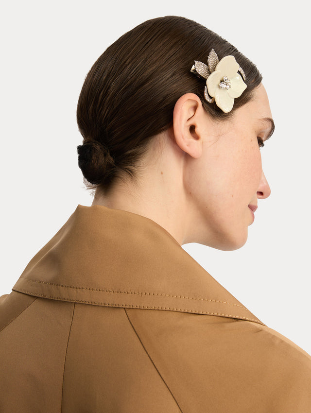 Silver and white Pearl Blossom Hair Clip featuring enamel petals with crystal accents and pavé-detailed silver leaves. Side View.