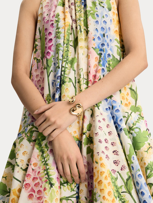 Gold Swirl Heart Cuff Bracelet featuring a sculpted heart motif with fluid, swirling details. Front View.