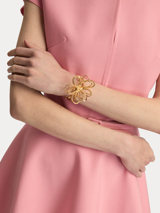 Gold Threaded Flower Bracelet Cuff featuring an openwork abstract bow design with looping curves. Front View.