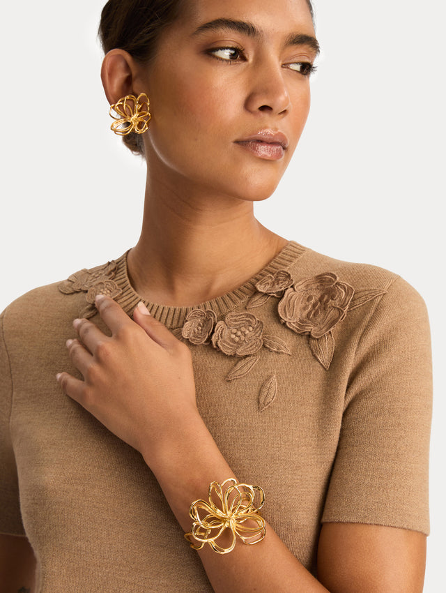 Gold Threaded Flower Bracelet Cuff featuring an openwork abstract bow design with looping curves. Front View.