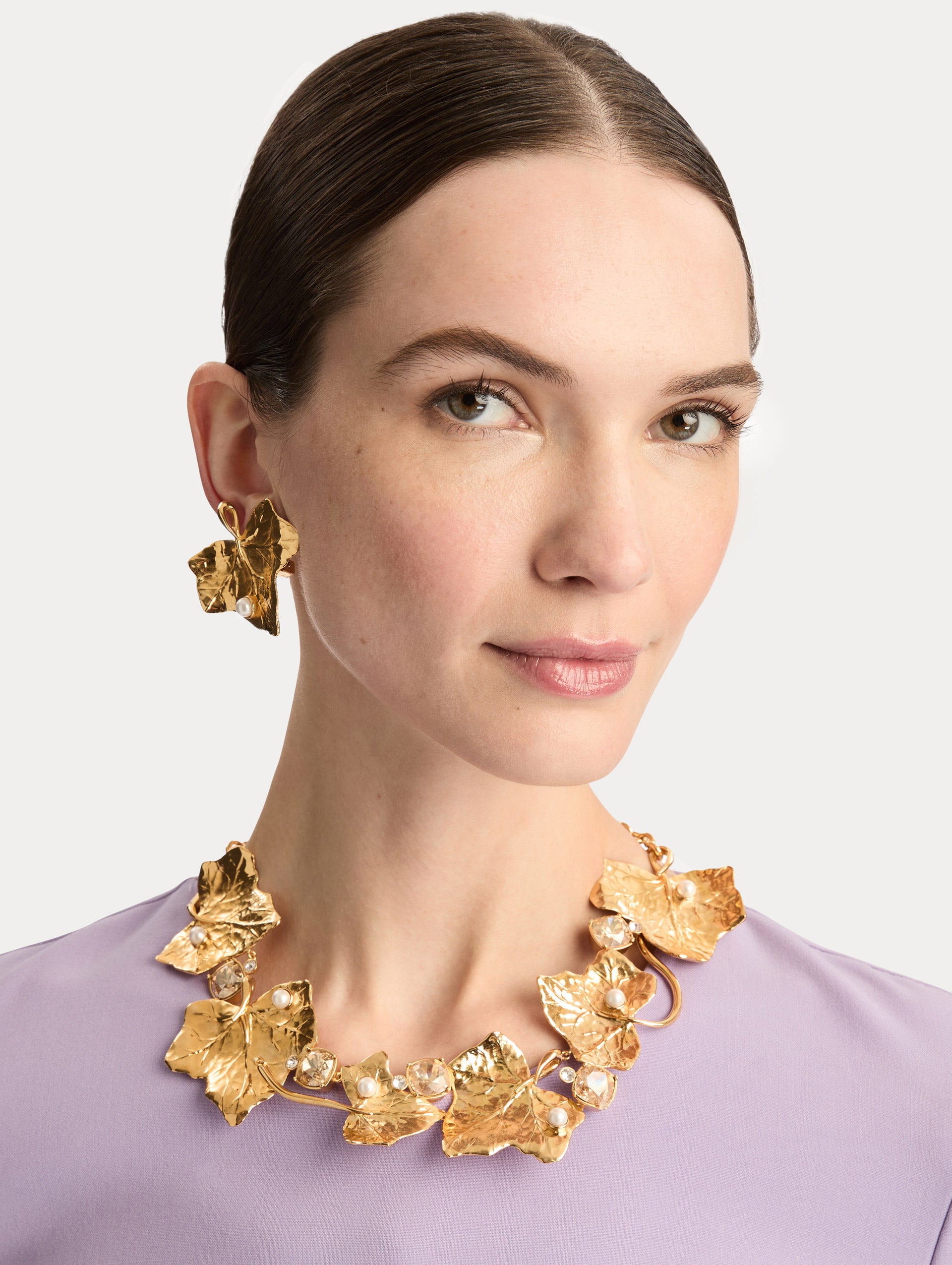 Gold Ivy Vine Necklace accented with pearls and faceted crystals on a mixed chain and vine-like structure. Side View.