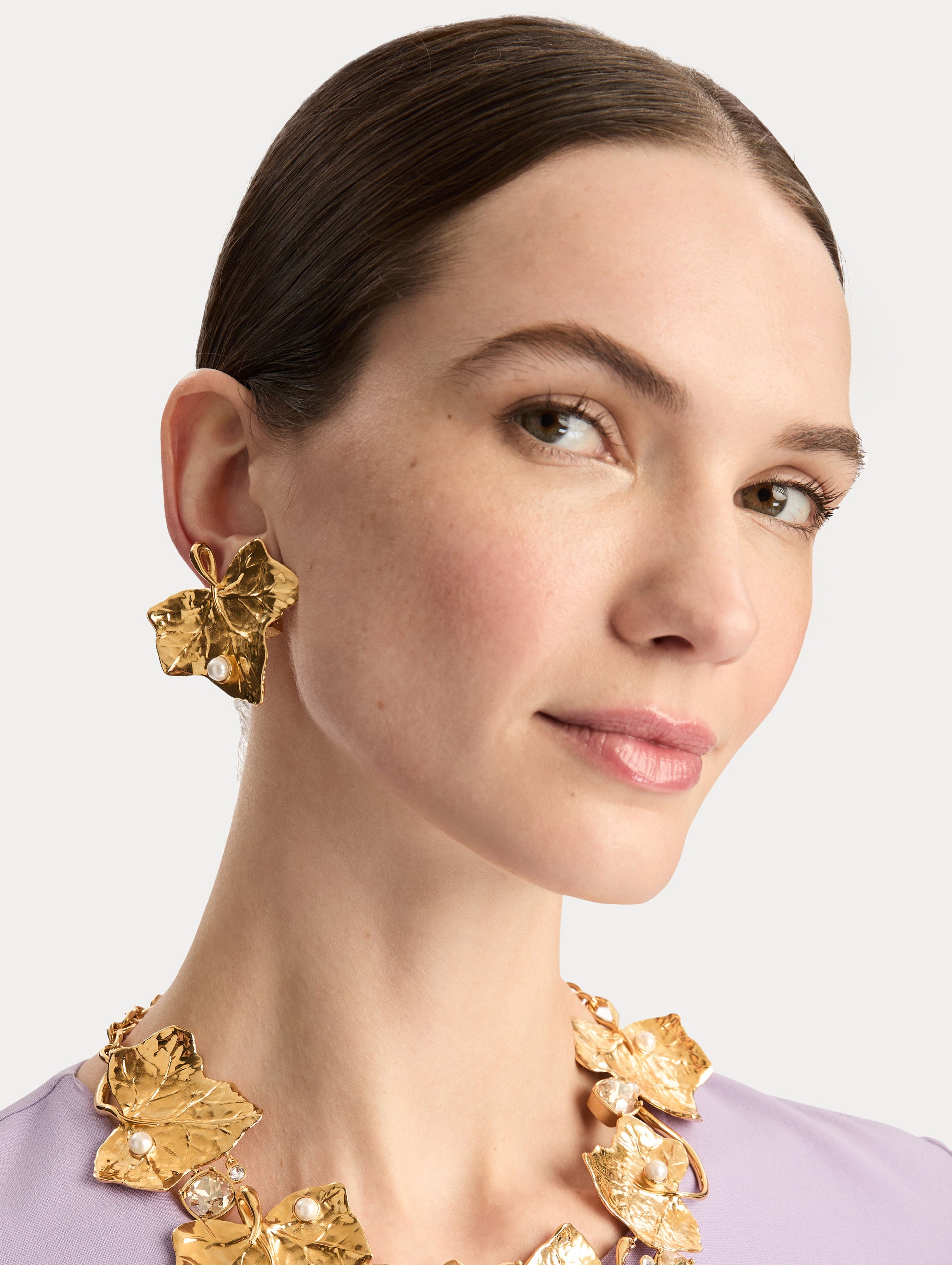 Gold Ivy Vine Necklace accented with pearls and faceted crystals on a mixed chain and vine-like structure. Side View.