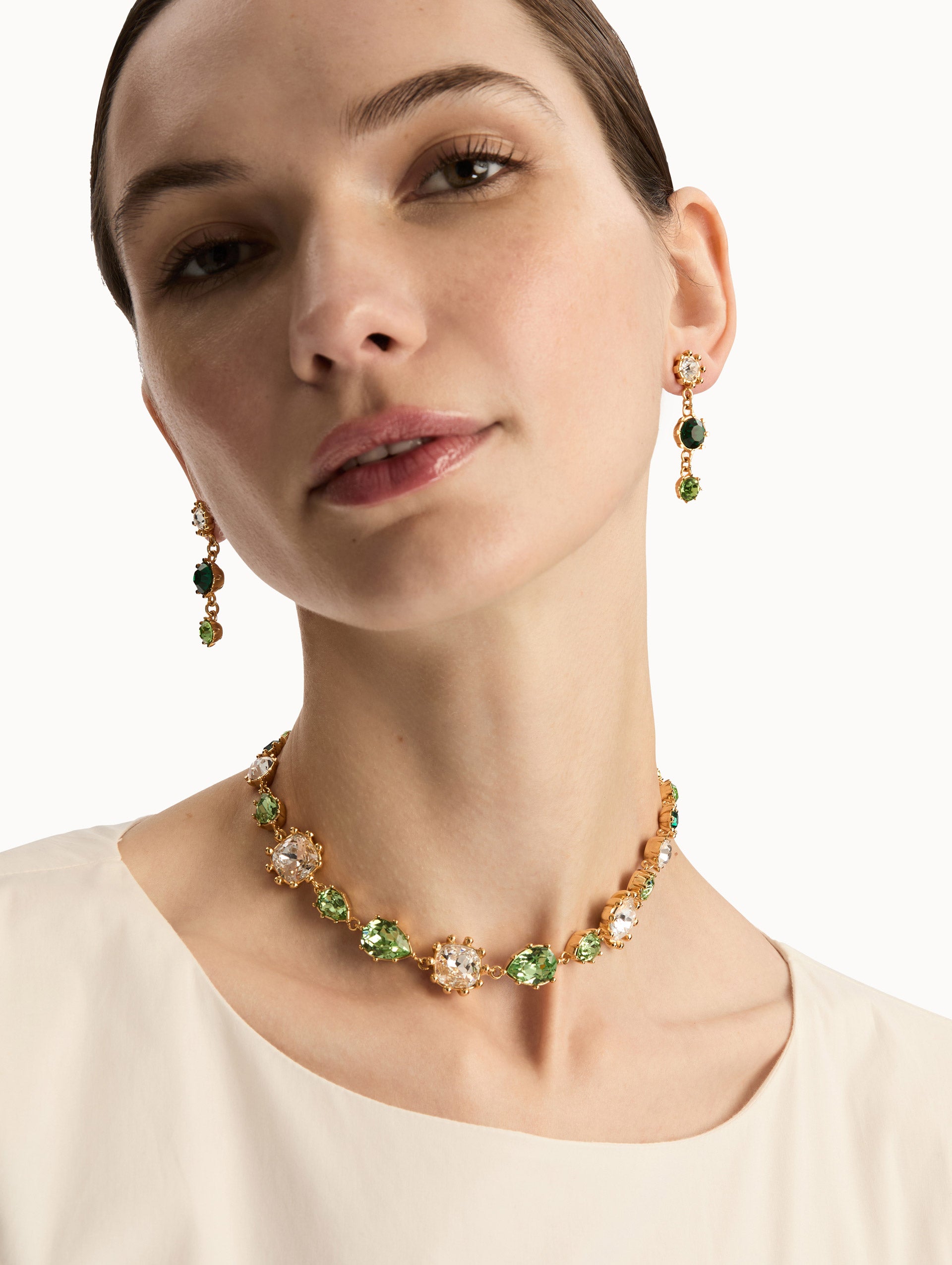 Gold Faceted Crystal Necklace featuring bezel-set crystals in green, champagne, and clear tones with adjustable chain.