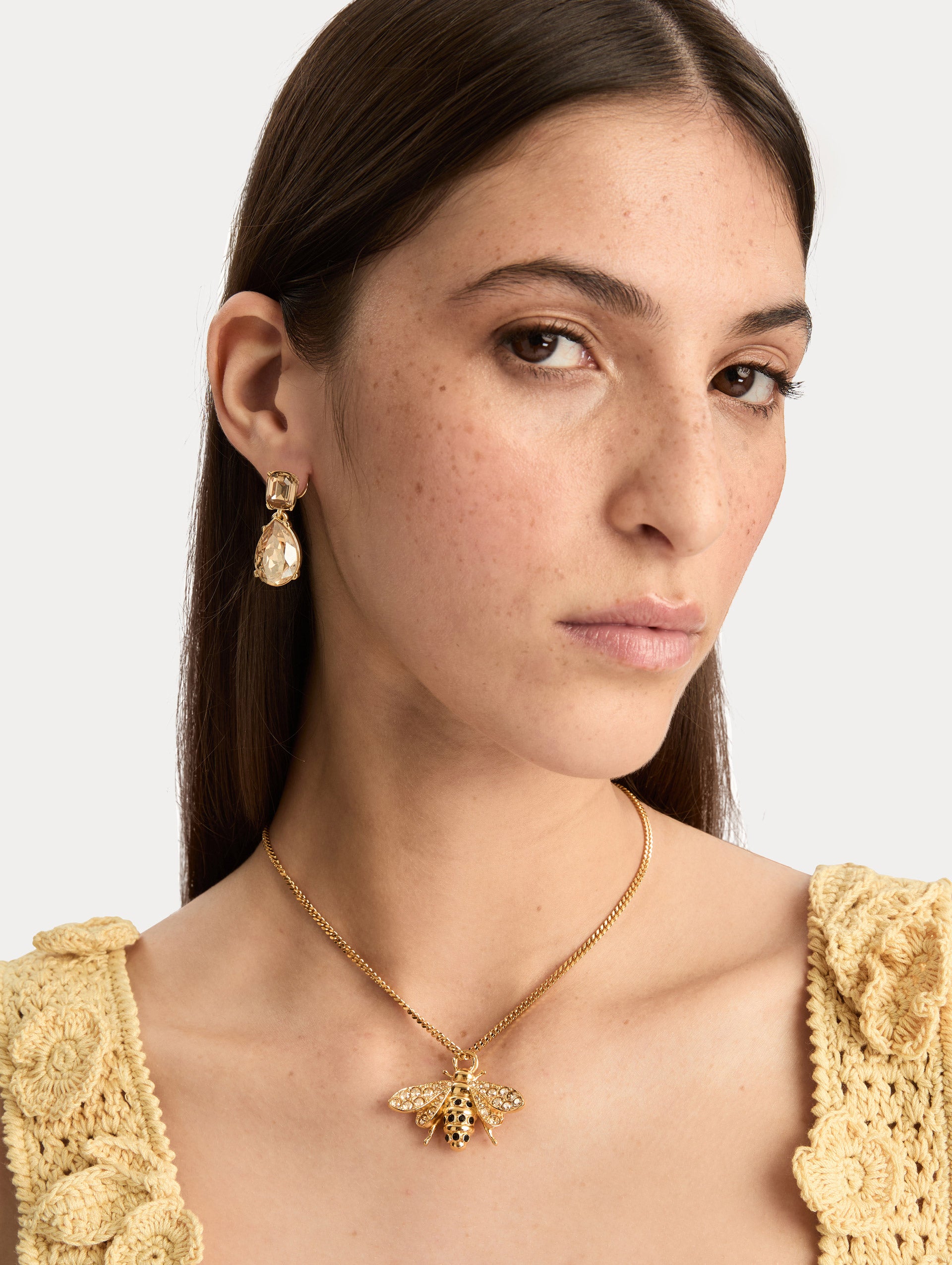 Gold Bee Pendant Necklace featuring a crystal-embellished charm on a fine chain. Front View.