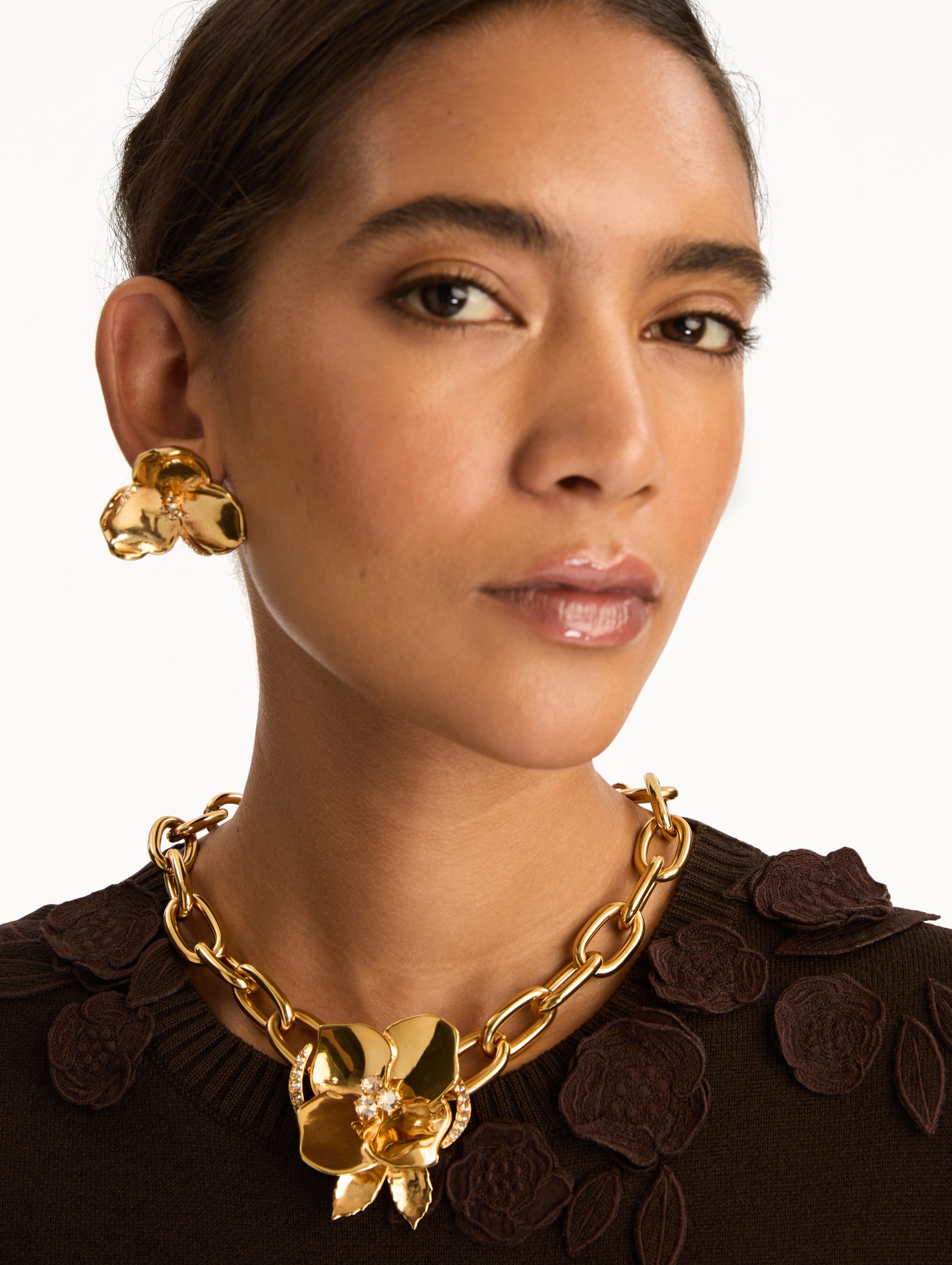 Gold Blossom Chain-Link Necklace featuring a sculpted floral charm with crystal center accents. Front View.