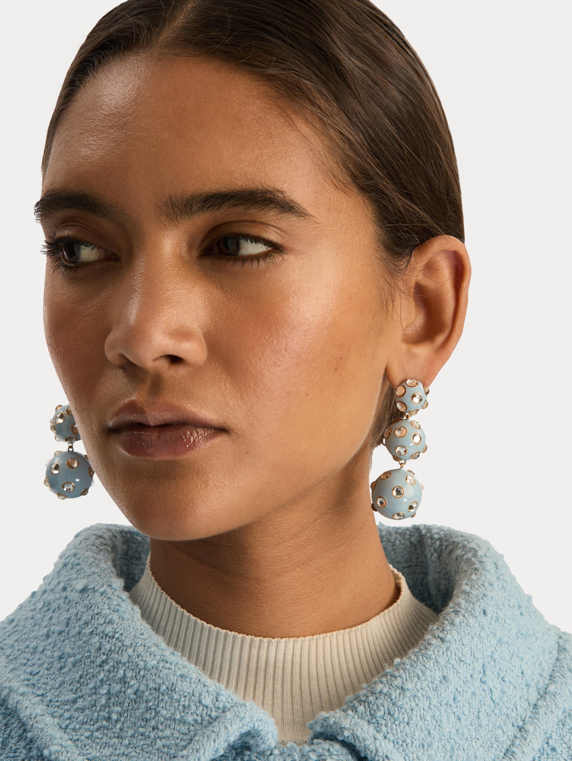 Blue Enamel Cabochon Drop Clip-On Earrings with three graduated orb shapes, accented by circular gold-trimmed crystal inlays. Front View.