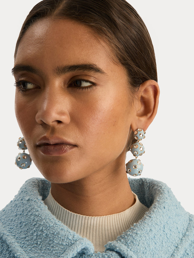 Blue Enamel Cabochon Drop Clip-On Earrings with three graduated orb shapes, accented by circular gold-trimmed crystal inlays. Front View.
