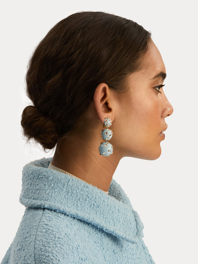 Blue Enamel Cabochon Drop Clip-On Earrings with three graduated orb shapes, accented by circular gold-trimmed crystal inlays. Side View.