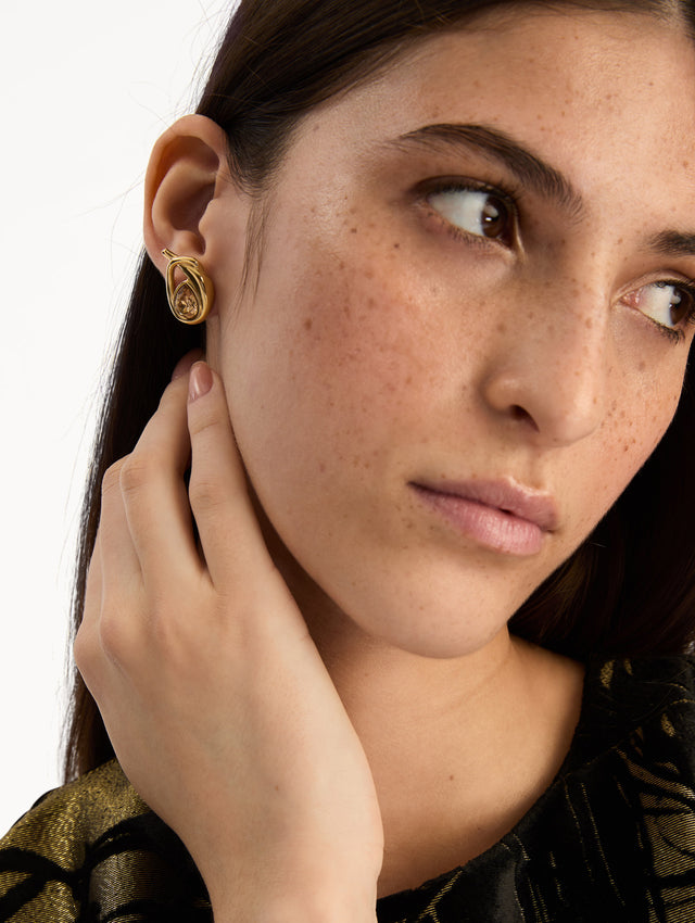 Gold Looped Teardrop Earrings featuring teardrop brown crystals encased in a twisted knot design. Zoom View. 