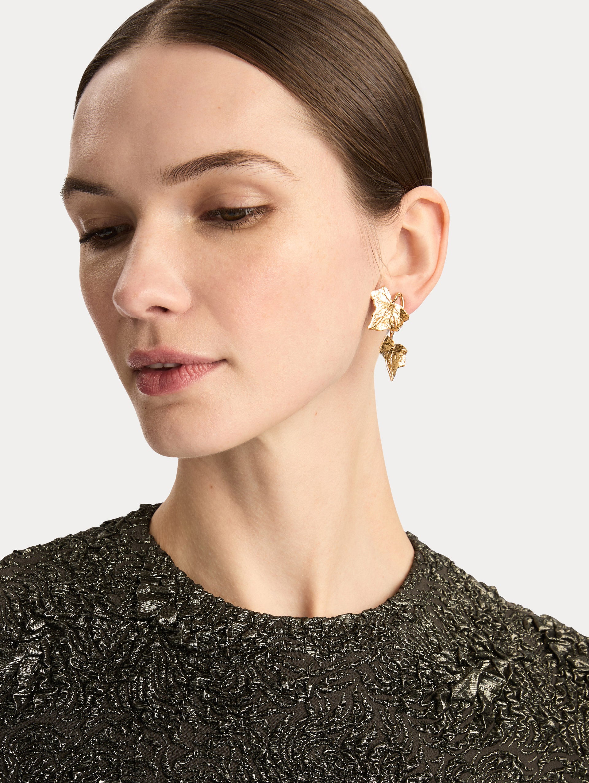 Gold Ivy Vine Drop Earrings featuring double leaf motifs with textured detailing. Side View.