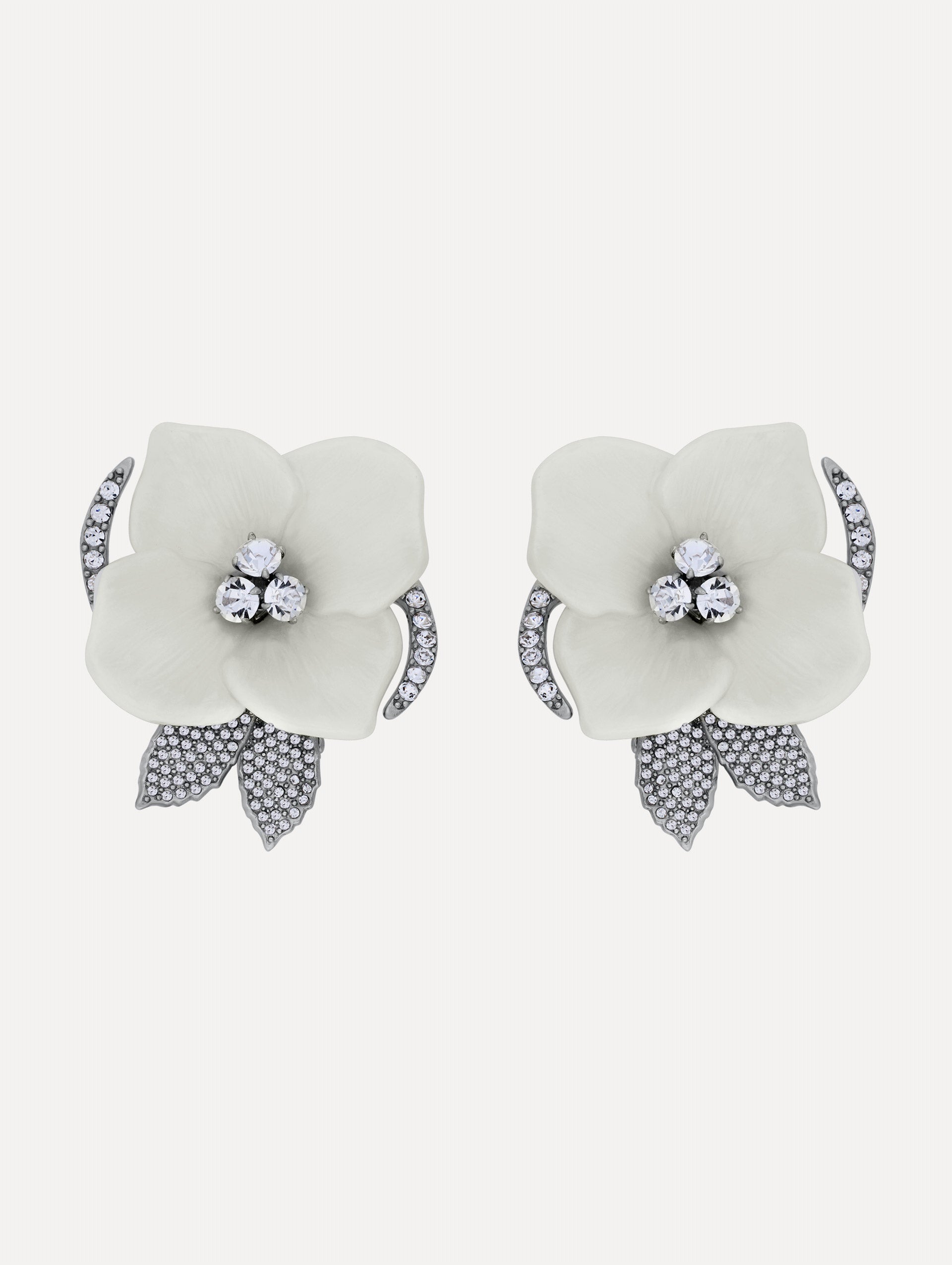 White and silver Pearl Blossom Clip-On Earrings featuring enamel petals, crystal centers, and pavé leaf accents.