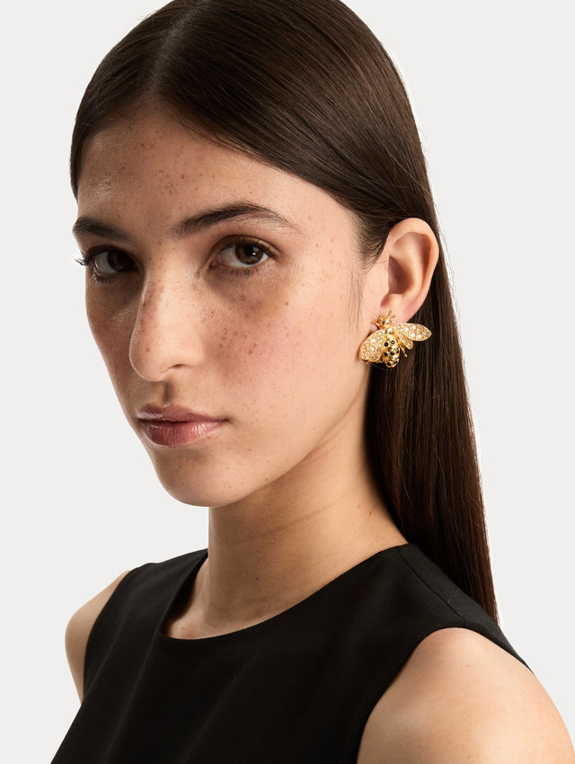 Gold Bee Clip-On Earrings with crystal-encrusted wings and black enamel stripes. Side View.