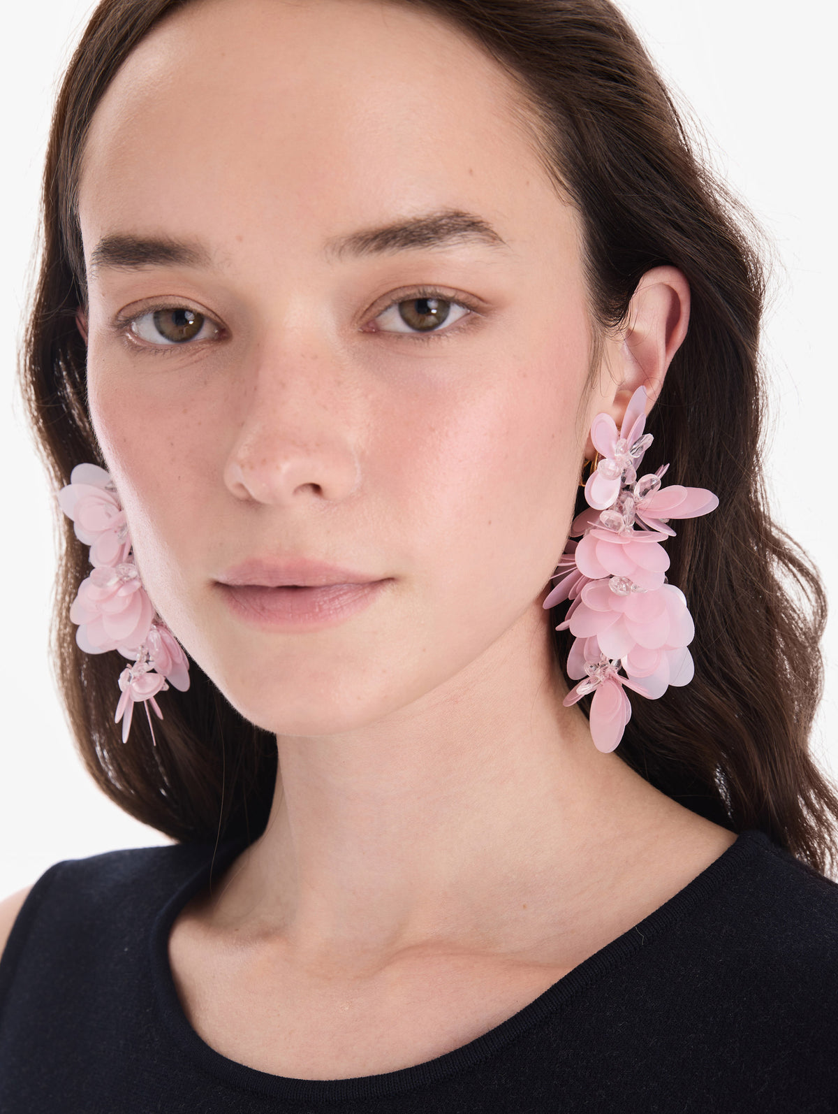 The model is wearing sequin cascade earrings. Front view.