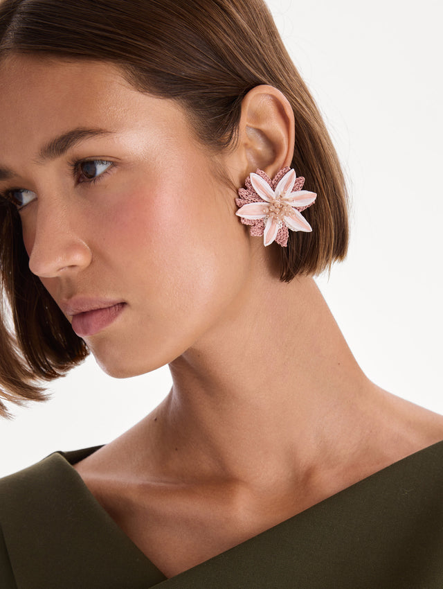 The model is wearing beaded lily earrings. Front view.