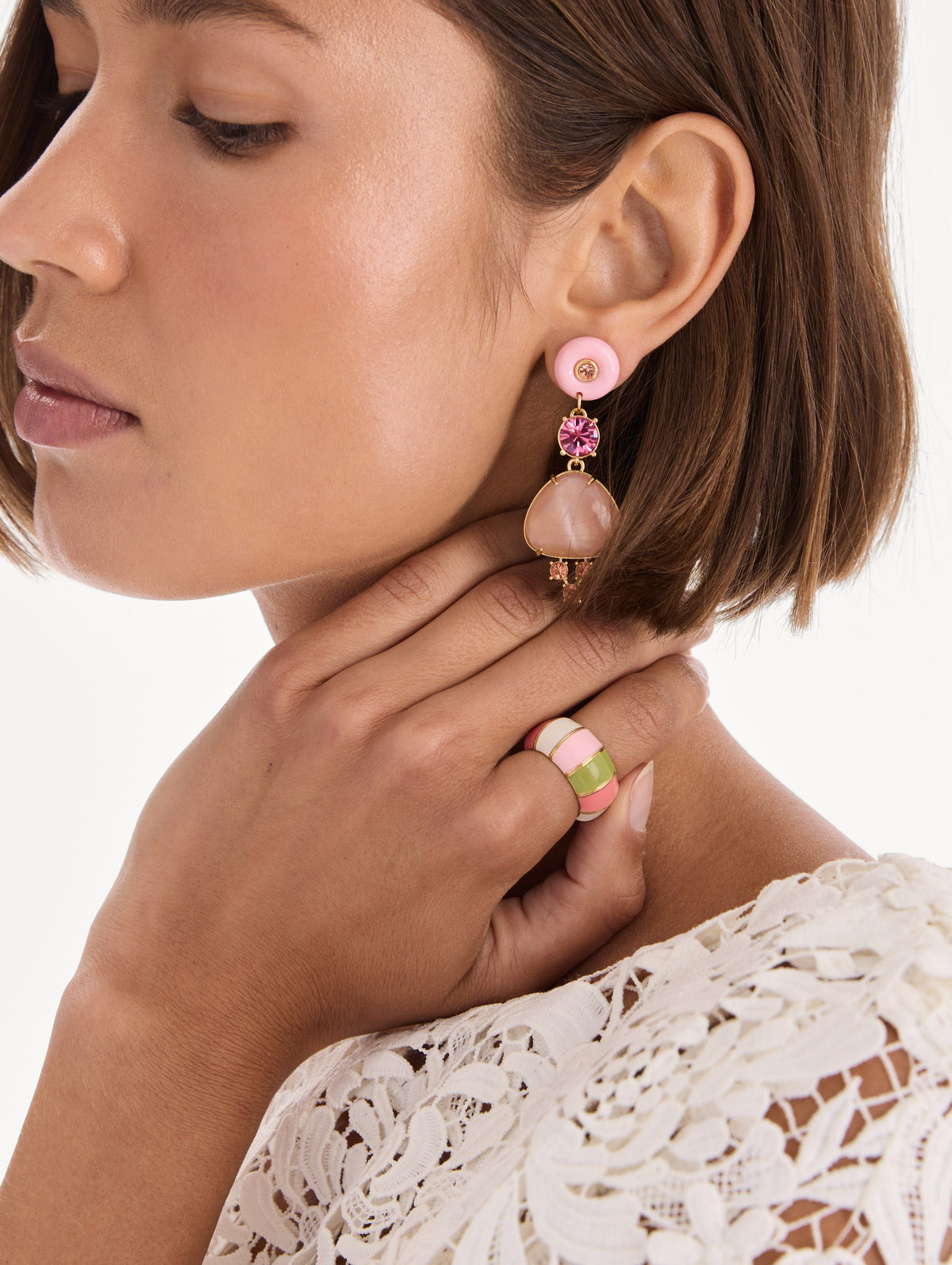 The model is wearing an enamel link ring. Front view.