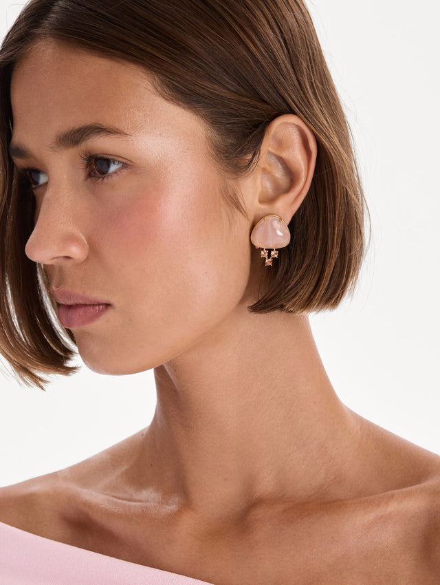 The model is wearing cabochon stud crystal earrings. Front view.