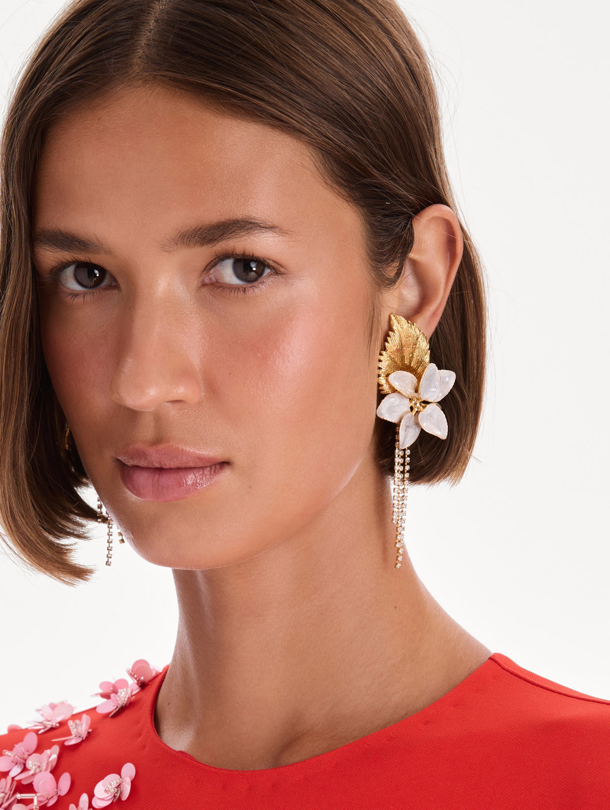 The model is wearing pear flower chandelier earrings. Front view.