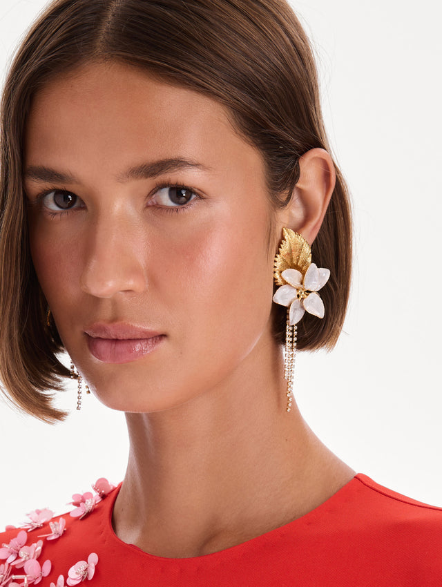 The model is wearing pear flower chandelier earrings. Front view.