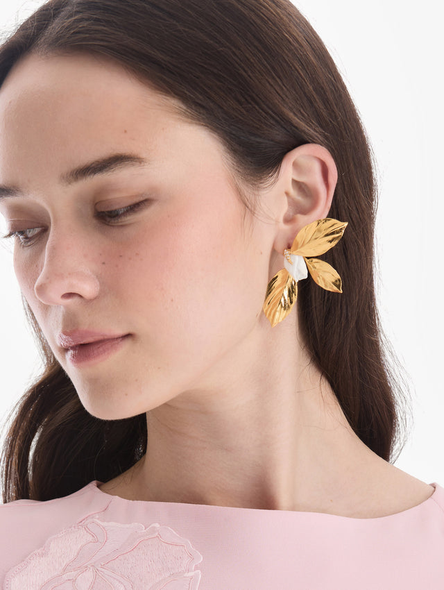 The model is wearing gardenia bud and leaves earrings. Front view.