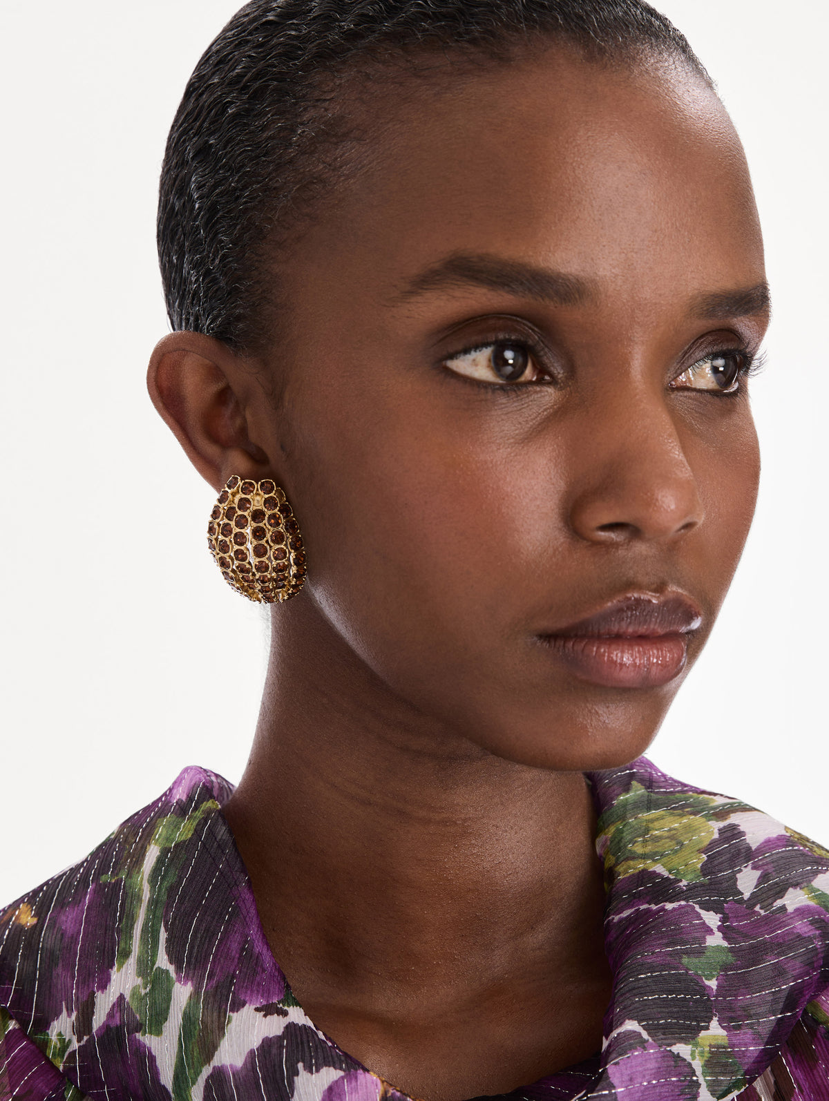 The model is wearing crystal domed earrings. Front view.