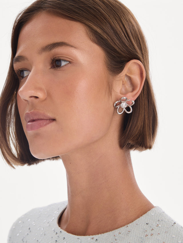 The model is wearing O flower crystal earrings. Front view.