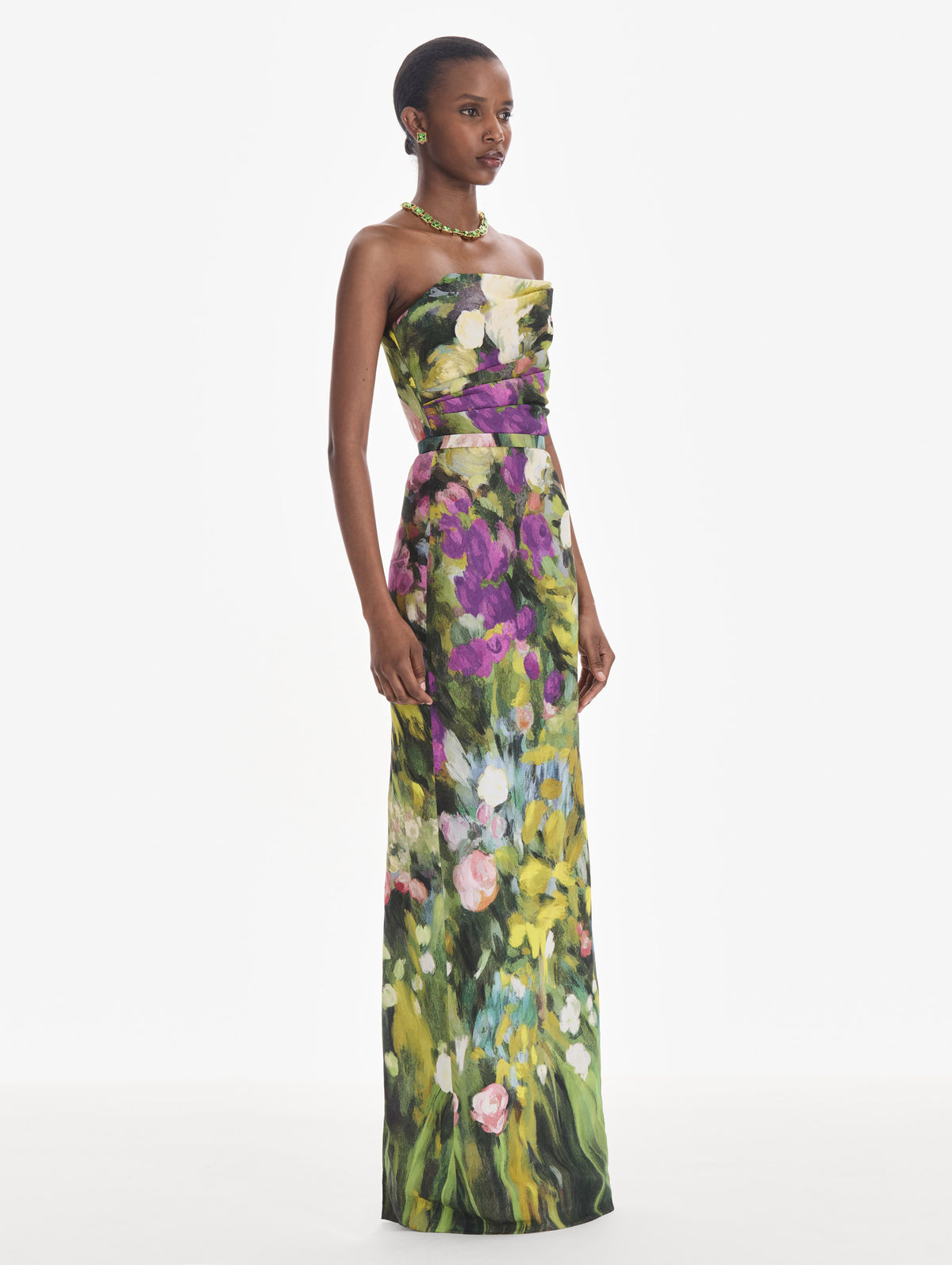 The model is wearing a strapless abstract garden faille gown. Side view.