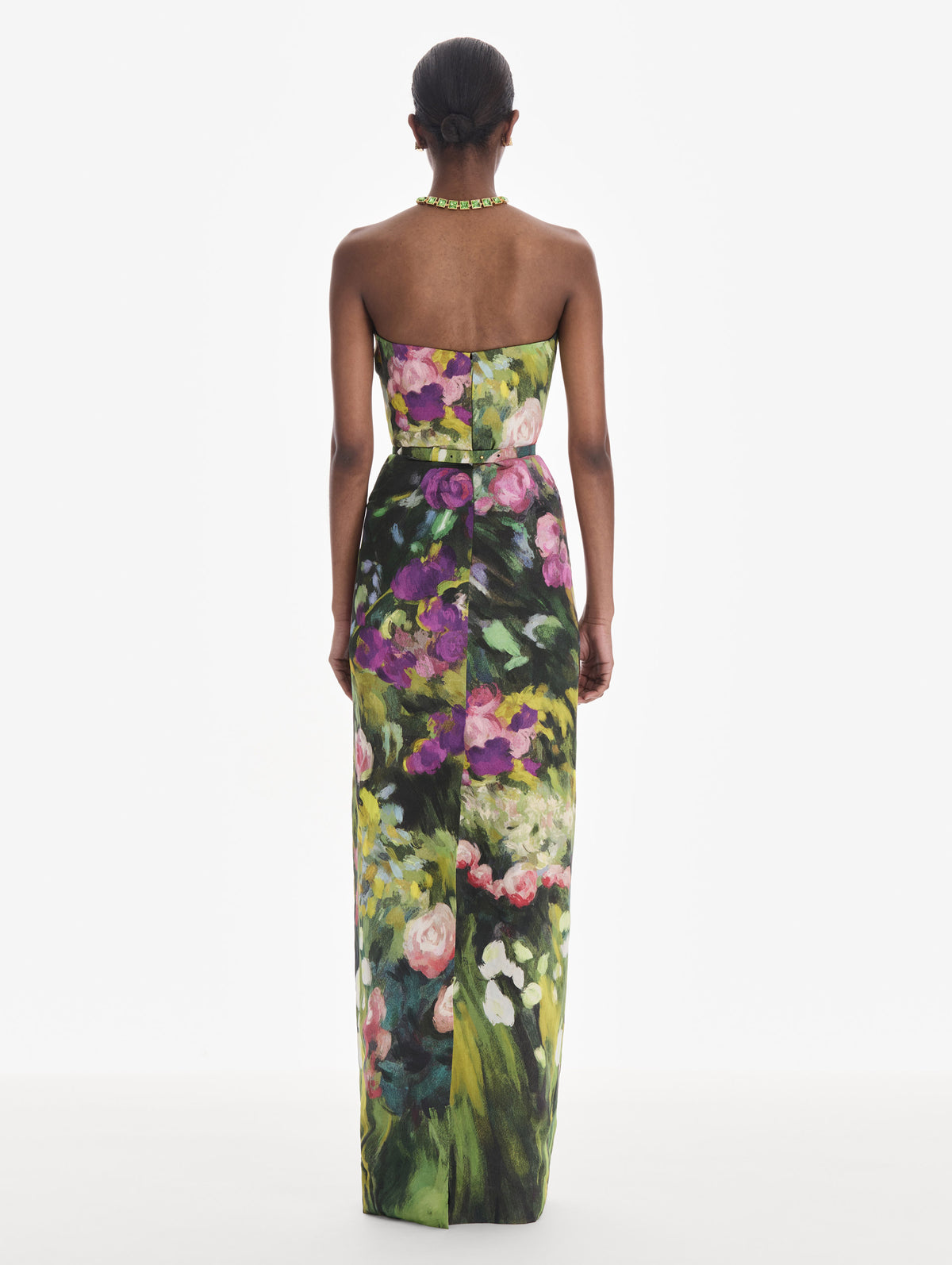 The model is wearing a strapless abstract garden faille gown. Back view.
