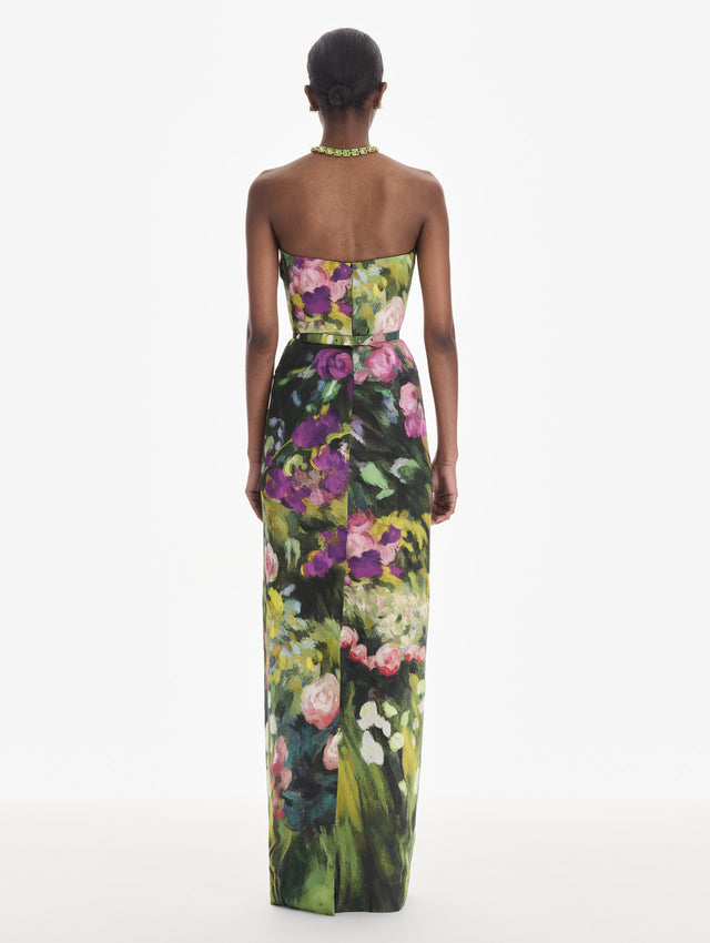 The model is wearing a strapless abstract garden faille gown. Back view.