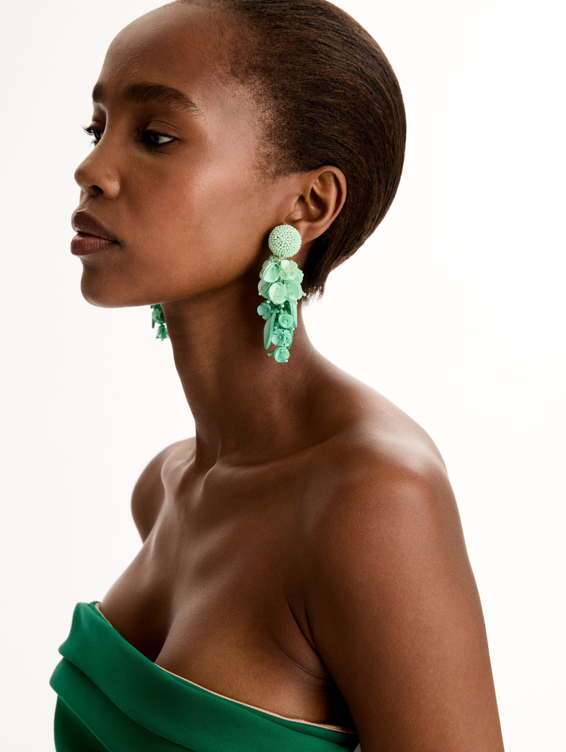 Aqua Cascading Petal Drop Clip-On Earrings featuring a textured domed stud and cascading floral clusters made from layered beads and petals. Front View.