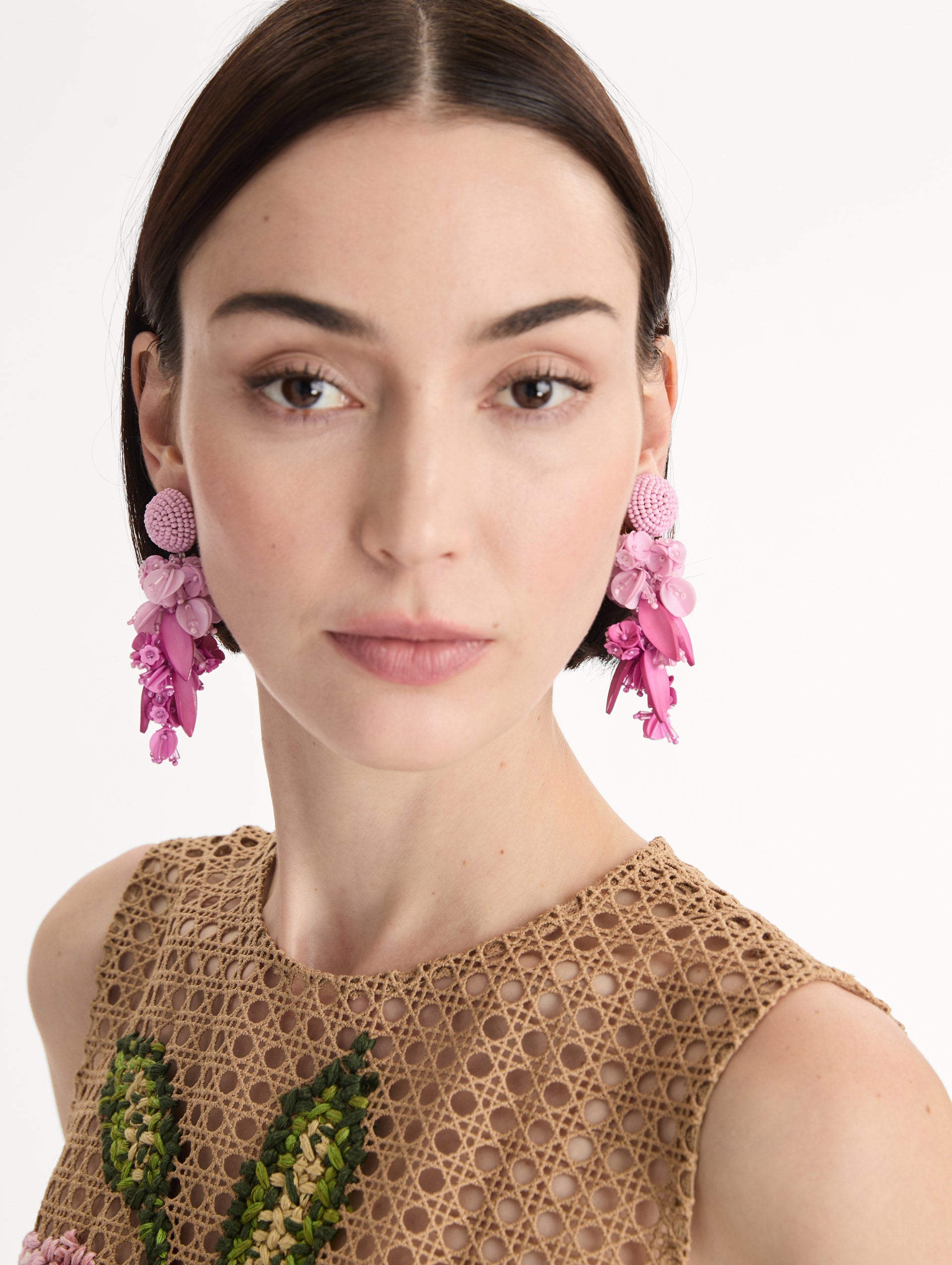 Pink Cascading Petal Drop Clip-On Earrings featuring a round beaded stud at the lobe with cascading clusters of glossy pink petals, beads, and floral-shaped components that create a layered, sculptural drop. Front View.