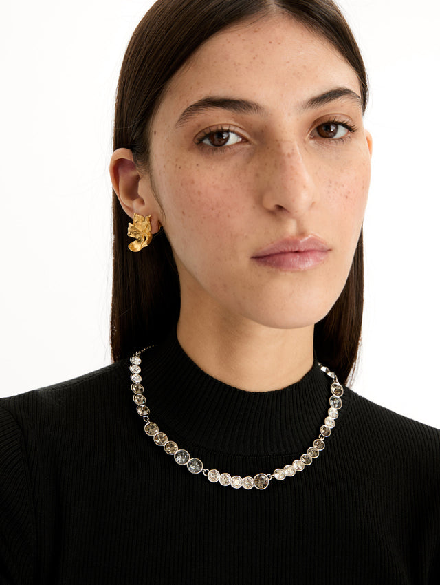 Gold Gradient Rhinestone Strand Necklace featuring a continuous row of round, clear stones in metal settings. Front View.