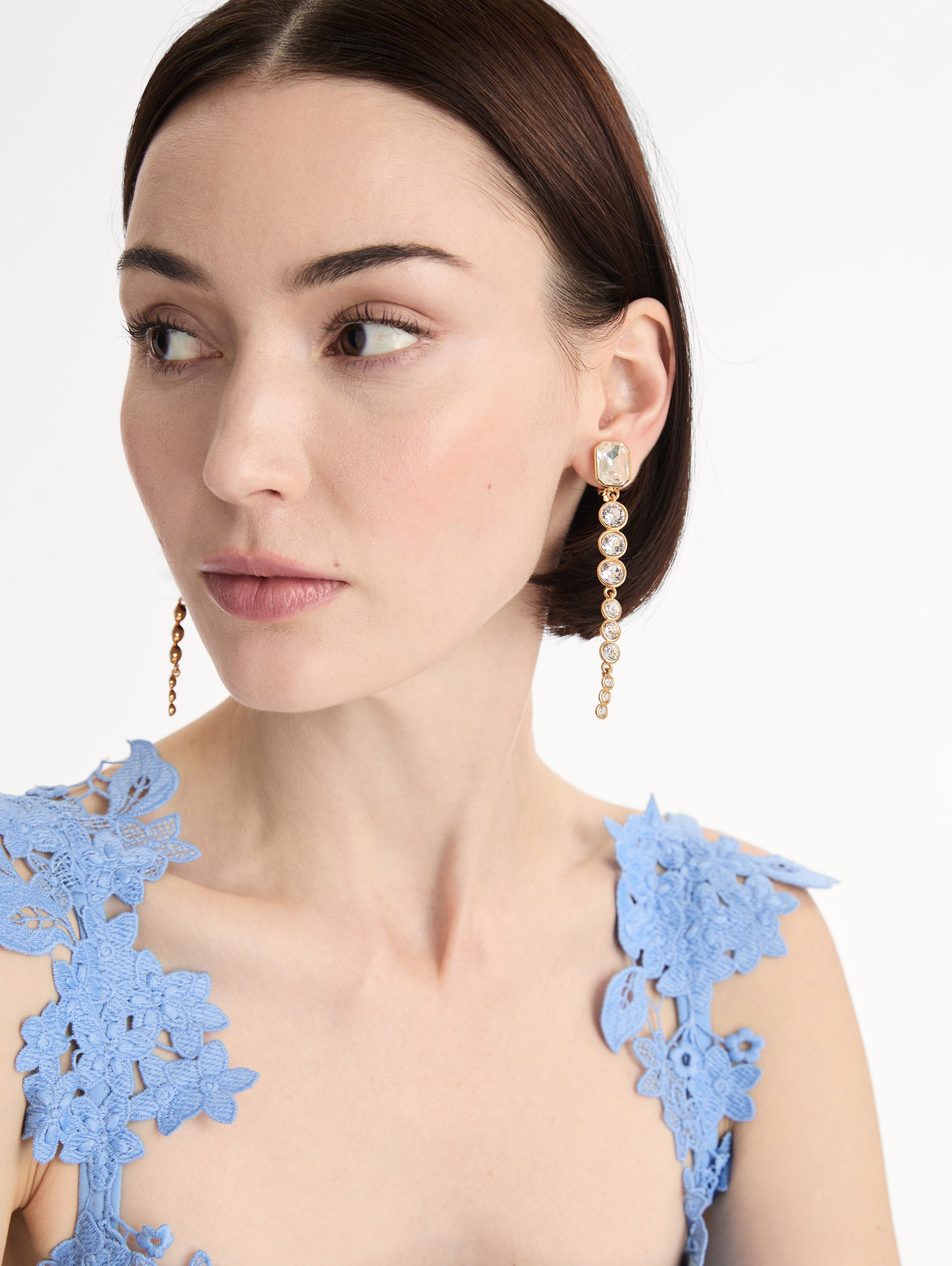 gold Cascading Mixed-Stone Drop Clip-On Earrings with clear circle and square crystals. Front View.