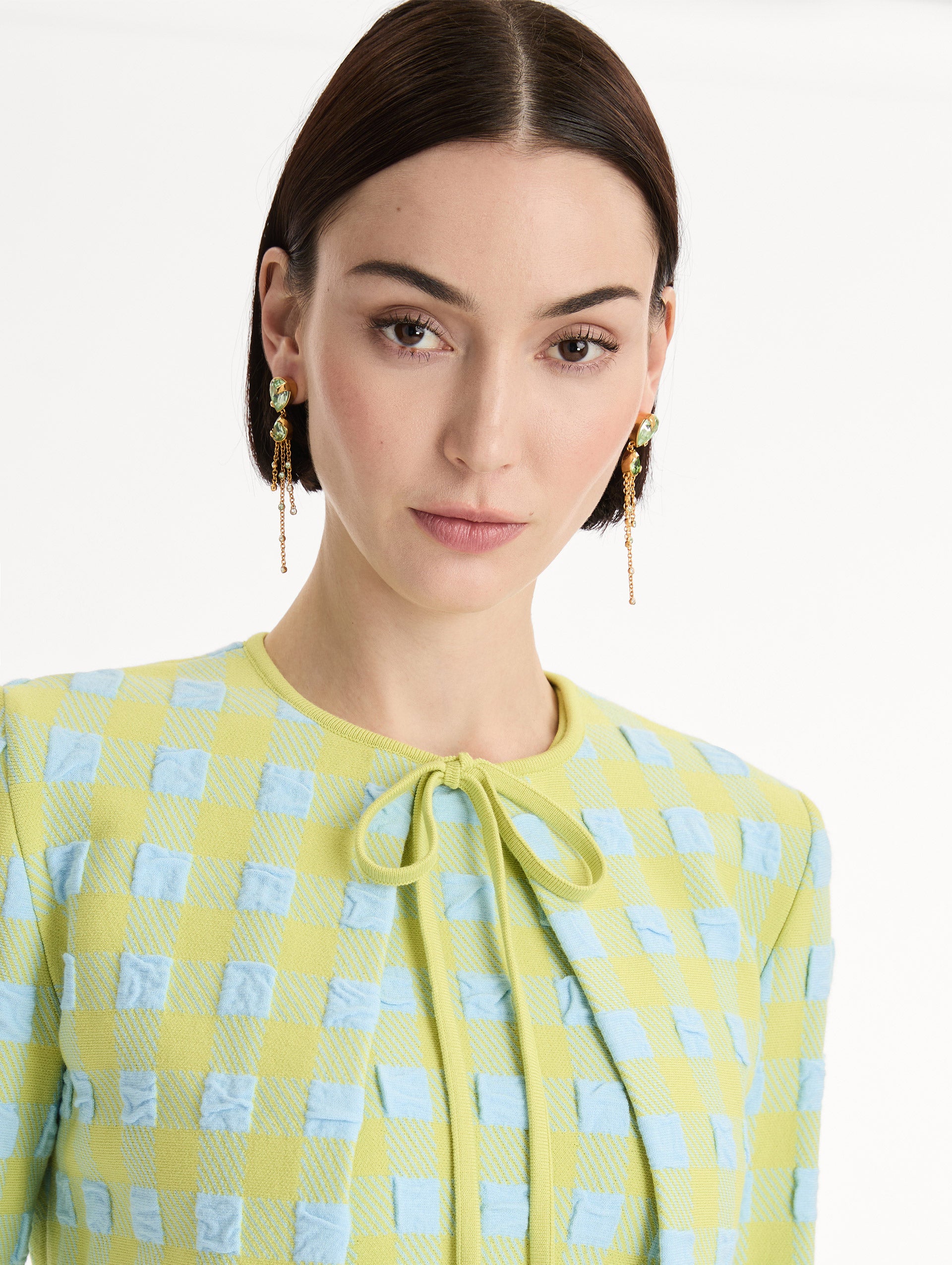 Green Pear-Cut Chandelier Earrings with teardrop crystals and gold chains cascading. Front View. 