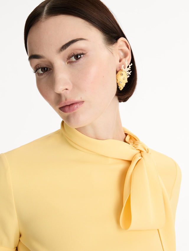 Gold Seashell and Coral Earrings with crystal accents and white coral detailing. Side View.