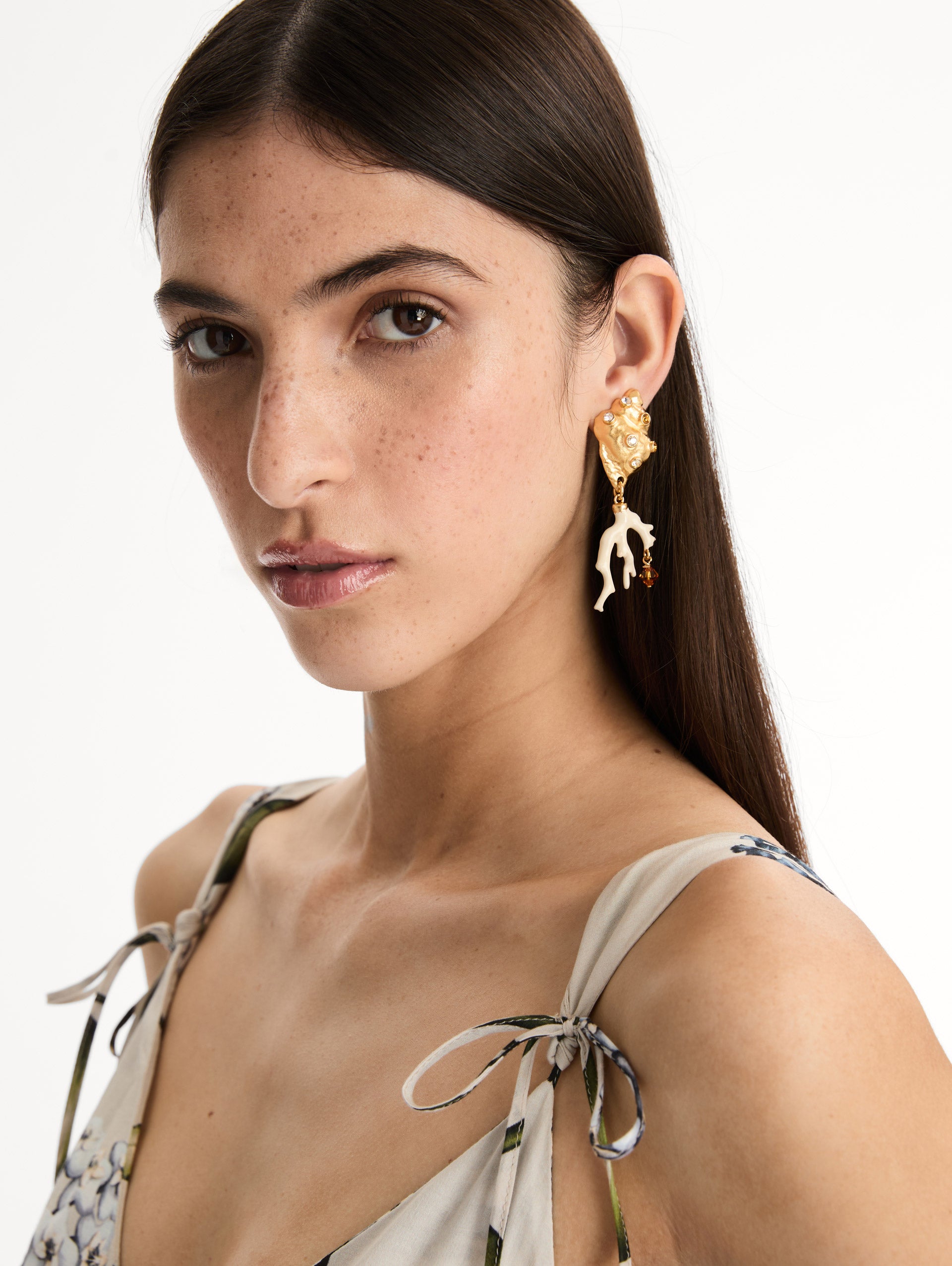 Seashell and Coral Clip-On Earrings with crystal accents and ivory coral-shaped dangles finished with amber crystals. Side View. 